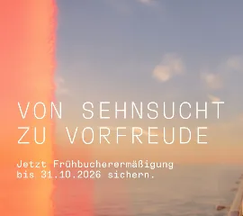 Zwei Gäste genießen bei Sonnenuntergang an Bord eines Schiffes von Hapag-Lloyd Cruises mit Champagner den Blick über das Meer – Kampagne Von Sehnsucht zu Vorfreude mit Frühbucherermäßigung bis 31. Oktober 2026.