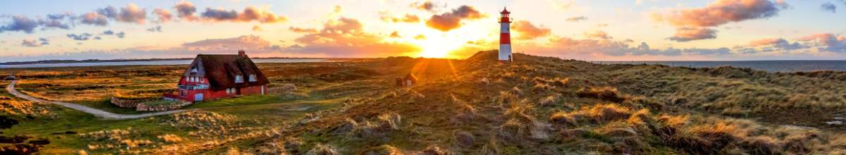Sylt bei Sonnenuntergang mit einem Haus und Leuchtturm