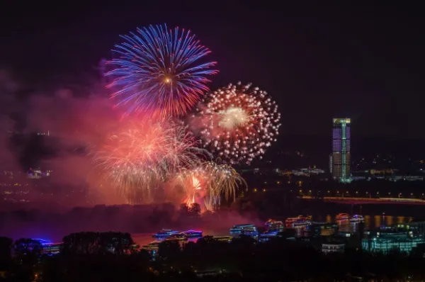 Rhein in Flammen Bonn Ein Feuerwerk direkt am Rhein neben einem Hochhaus bei Nacht.