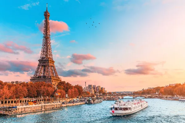 Abendstimmung in Paris: Eiffelturm und Seine-Schifffahrt Romantisches Paris: Blick auf den Eiffelturm und die Seine mit Ausflugsboot bei Sonnenuntergang - Ziel einer Flusskreuzfahrt oder eines Landausflugs.