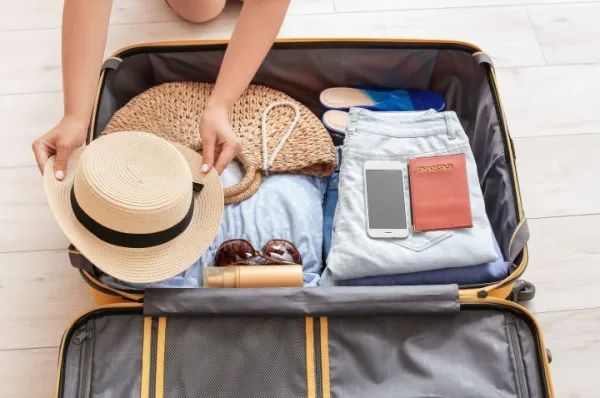 Eine Person packt einen Koffer für ihre Weltreise Kreuzfahrt.