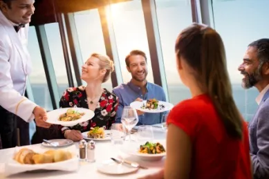 2-teiliges Bild: Links Pärchen an einem Tisch im Außenbereich eines Costa Schiffes. Die beiden genießen ein Abendessen mit Spaghetti Napoli, Wein und Brot und genießen den Blick auf den Sonnenuntergang. Rechts Häuser im Park Güell in Barcelona.