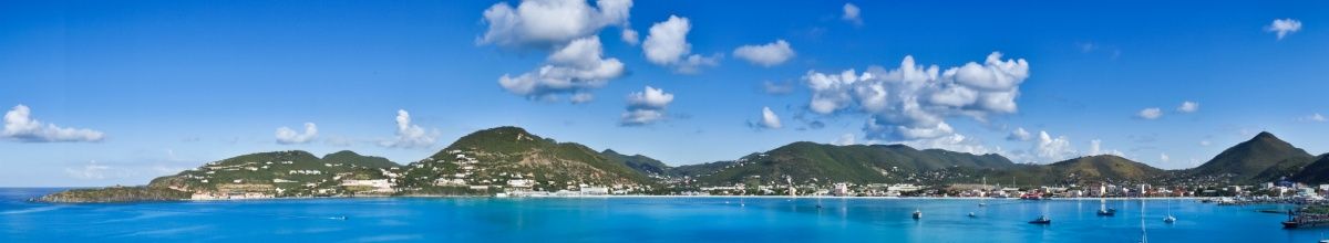 Blick auf die Küstenlinie von Philipsburg mit Bergen im Hintergrund.