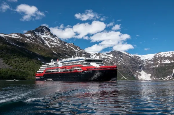 MS Fridtjof Nansen Außenansicht der MS Fridtjof Nansen, im Hintergrund schneebedeckte Berge.