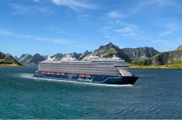 Rendering von <i>Mein Schiff Flow</i> in einer Destination mit einer Gebirgsketter und grünen Wiesen im Hintergrund. Das Schiff ist dabei von seitlich vorne zu sehen.