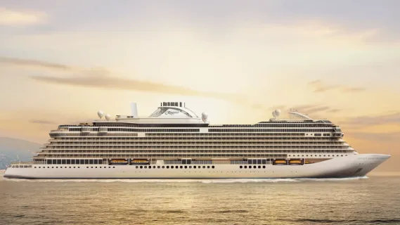 Das Schiff Seven Seas Prestige gleitet ruhig über das goldene Wasser, während die untergehende Sonne den Himmel in warme Farben taucht.