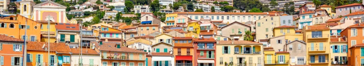 Eine Häuserfront in Villefranche-Sur-Mer mit bunten Häusern direkt an der Küste.