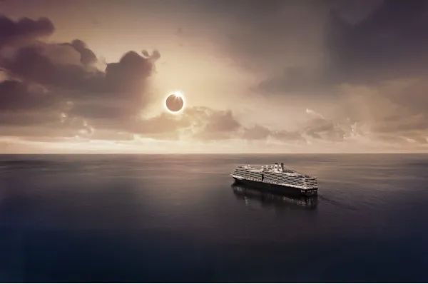 Ein Schiff von HAL auf dem weiten Meer, am Himmel sieht man eine Sonnenfinsternis.