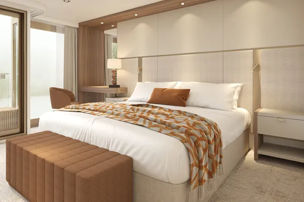 Beispielbild AMADEUS Suite mit einem Doppelbett, Spotlights, einem Schminktisch mit Stuhl und eine Bank vor dem Bett / Aufteilung und Ausstattung können variieren.