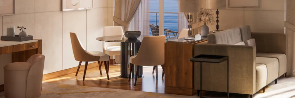 Beispielbild Junior Crystal Penthouse Suite mit einem Sofa und Esstisch mit vier Stühlen sowie Panorama-Türen zur privaten Veranda.