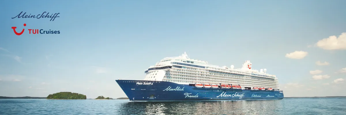 Mein Schiff/TUI Cruises Frühbucher Kreuzfahrt <em>Mein Schiff 6</em> vor einer Inselgruppe im Ozean. Buchen auch Sie eine Kreuzfahrt mi Frühbucher-Rabatt.