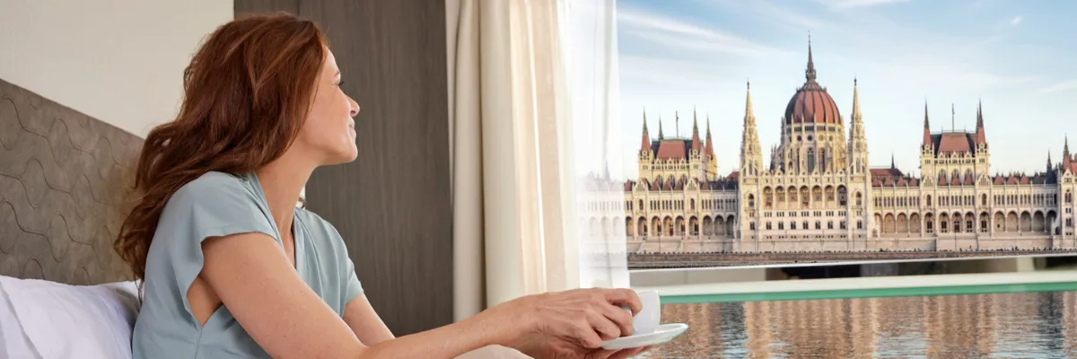 AMADEUS Flusskreuzfahrten 2027 – Donau-Reisen mit Panoramablick auf Budapest Blick aus der Kabine auf das Parlamentsgebäude in Budapest während einer AMADEUS Donau-Flusskreuzfahrt 2027.