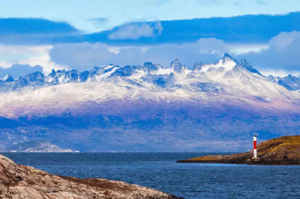 Leuchtturm mit beeindruckender Bergkulisse im Hintergrund in der Nähe der Stadt Ushuaia in Tierra del Fuego in Argentinien.