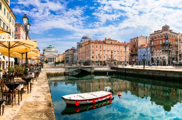 Canal Grande in Triest mit Booten und Café-Terrassen am Ufer.
