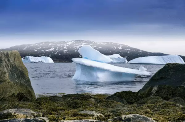 Eisberg auf dem blauen Meer mit blauem Himmel bei Qaqortoq, Grönland
