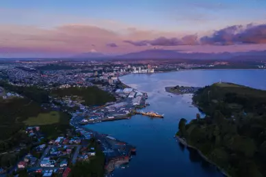 Blick über Hafen in Puerto Montt mit Schiffen auf blauem Wasser.