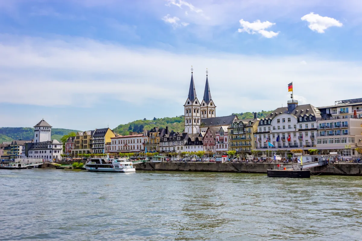 Flusskreuzfahrt durch eine schöne deutsche Altstadt Flusskreuzfahrtschiff auf ruhigem Fluss mit idyllischem Hintergrund einer deutschen Altstadt