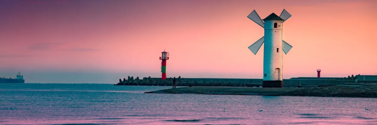 Der Leuchtturm von Swinemünde bei Sonnenuntergang: Erleben Sie diesen Ausblick bei einer Kreuzfahrt in der Ostsee.