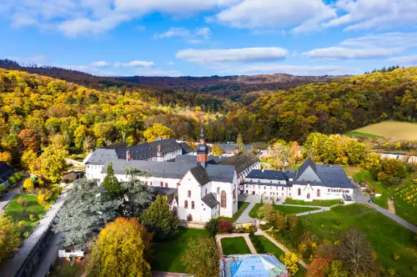 Das Kloster Eberbach liegt auf einem kleinen Hügel. Es strahlt romantisches Flair aus und besticht durch eine weiße Außenfassade mit verspielten Türmen und Dächern.